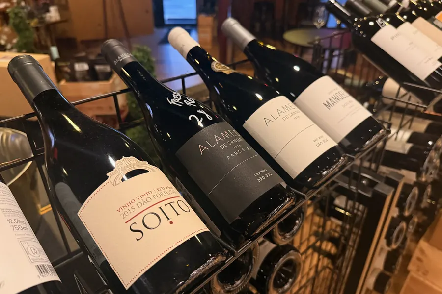 Dão wines racked at La Vid: Soitos, Alameda, and Alameda Parcelas bottles angled in a wire rack