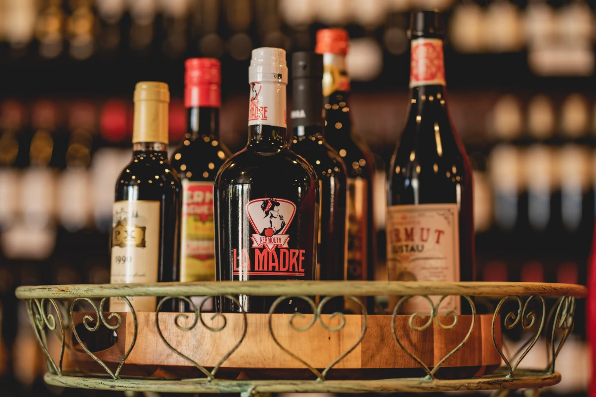 A shelf of Spanish vermut bottles at La Vid