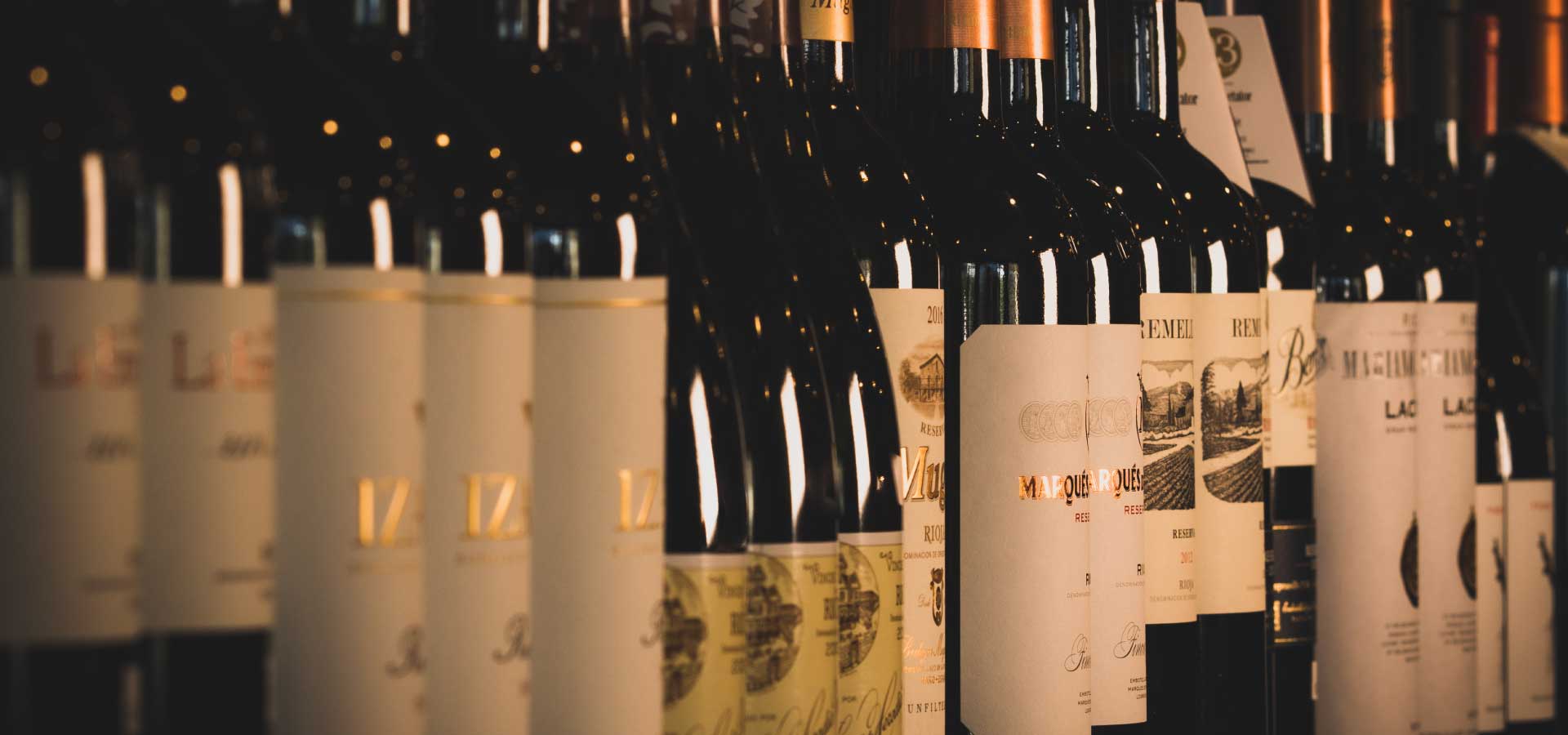 A row of Rioja bottles on the shelf at La Vid